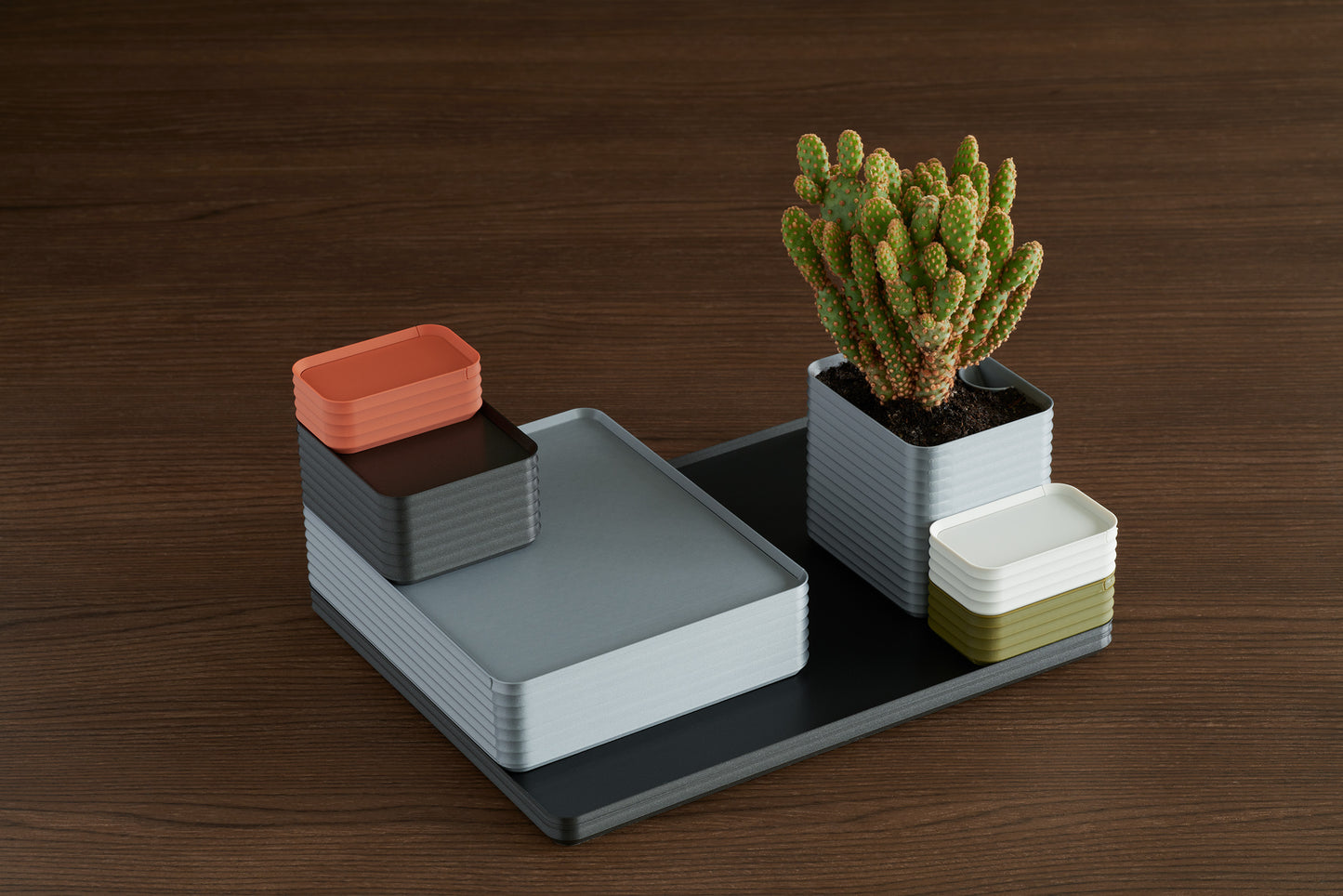 Modern terracotta, iron gray, silver, bone white, and army green Rib Series boxes styled with greenery on a walnut table — inspiring ways a Z Co Gift Card recipient can design their own personalized collection.
