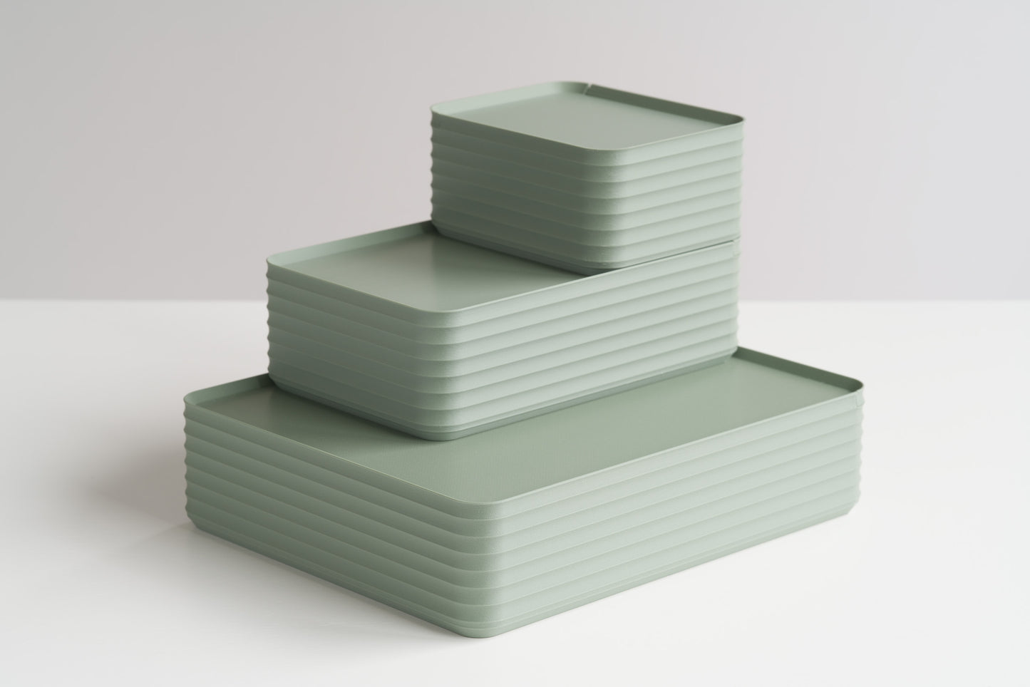 Three Z Co Rib Series Boxes in muted green arranged in a stepped formation on a white surface. Includes small, original, and double-wide sizes, highlighting modern ribbed storage design.