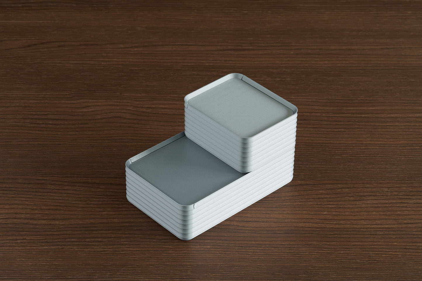 Z Co Rib Series silver boxes, small and original sizes stacked neatly on a walnut wood surface for size comparison.