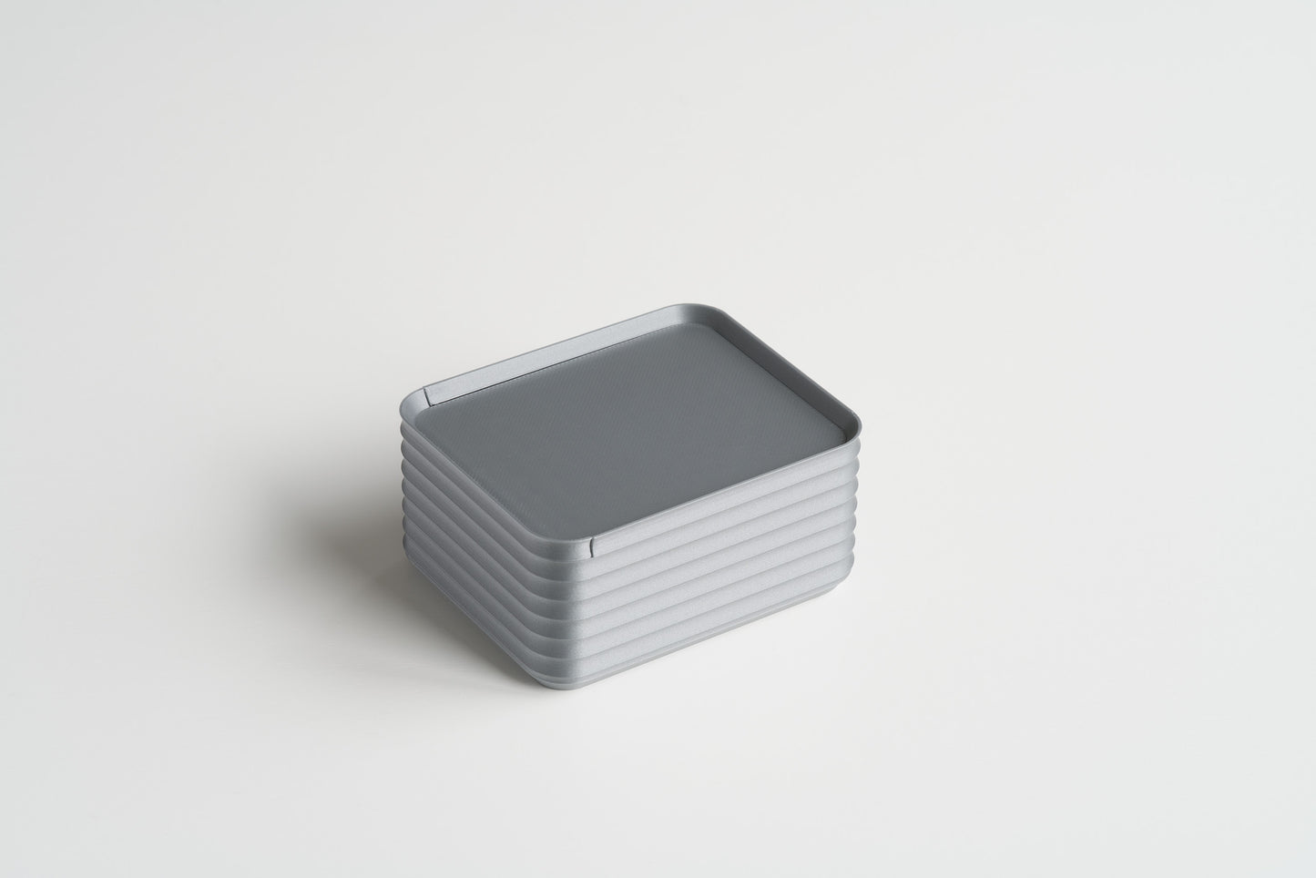 Small Silver Z Co ribbed box shown closed on a white background, highlighting its sleek and modern design.