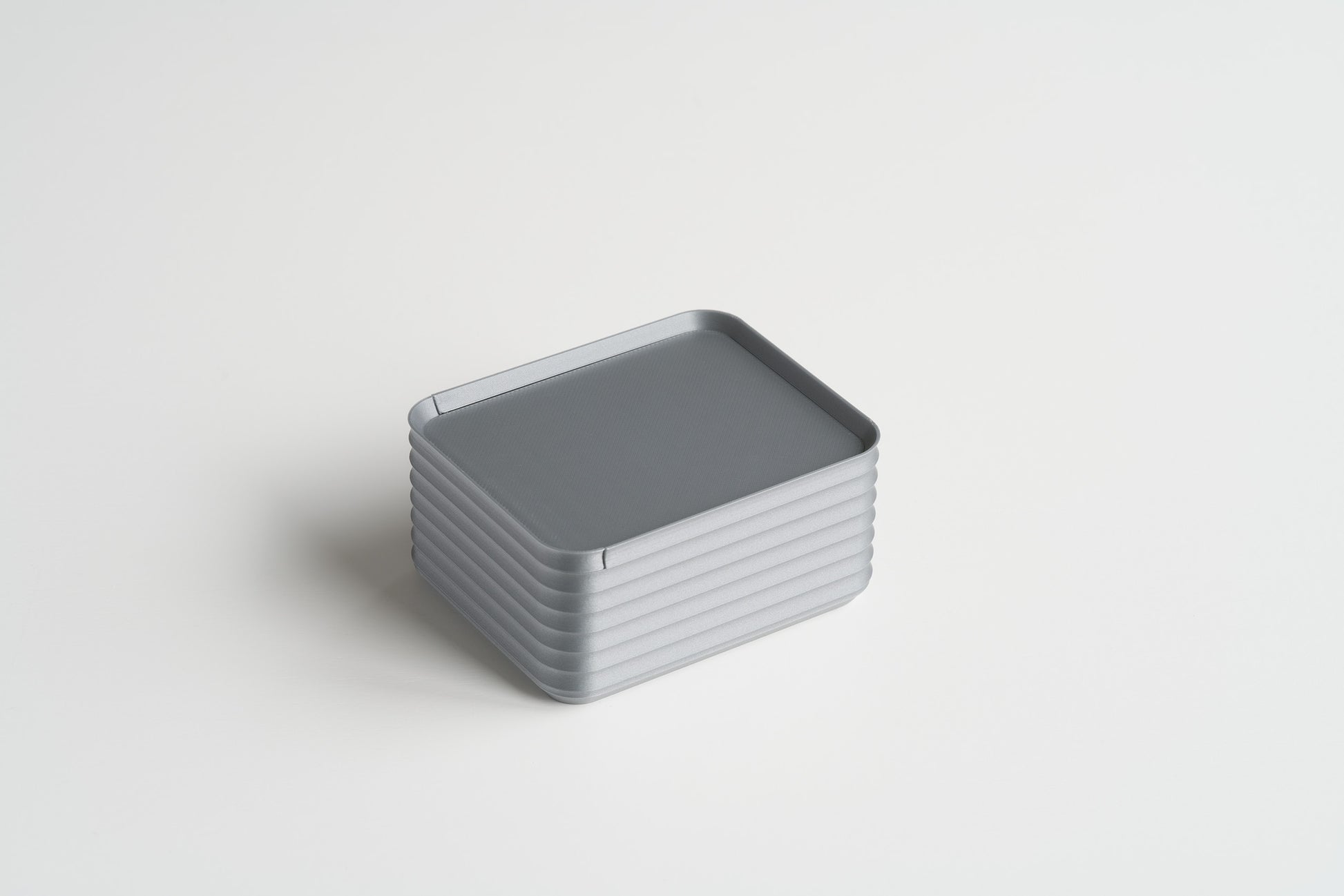 Small Silver Z Co ribbed box shown closed on a white background, highlighting its sleek and modern design.