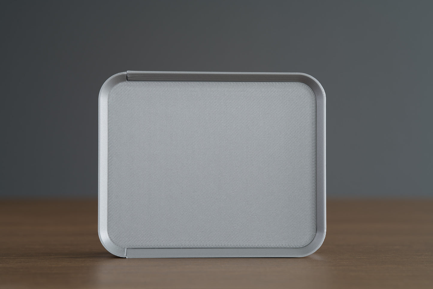 Small Silver Z Co ribbed box placed upright on its side, showing a full top view, photographed on a walnut surface.
