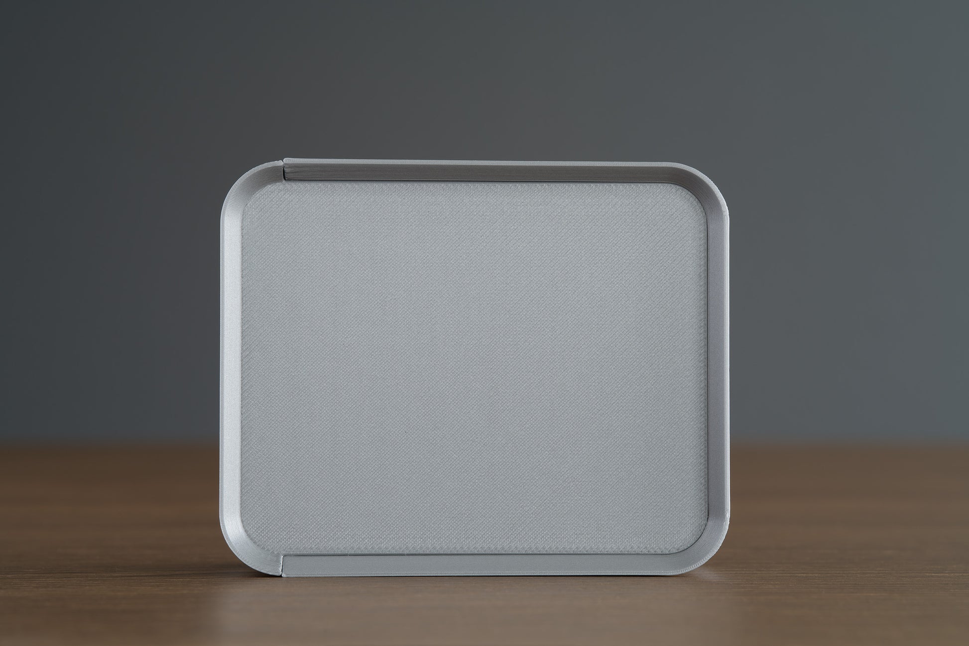 Small Silver Z Co ribbed box placed upright on its side, showing a full top view, photographed on a walnut surface.