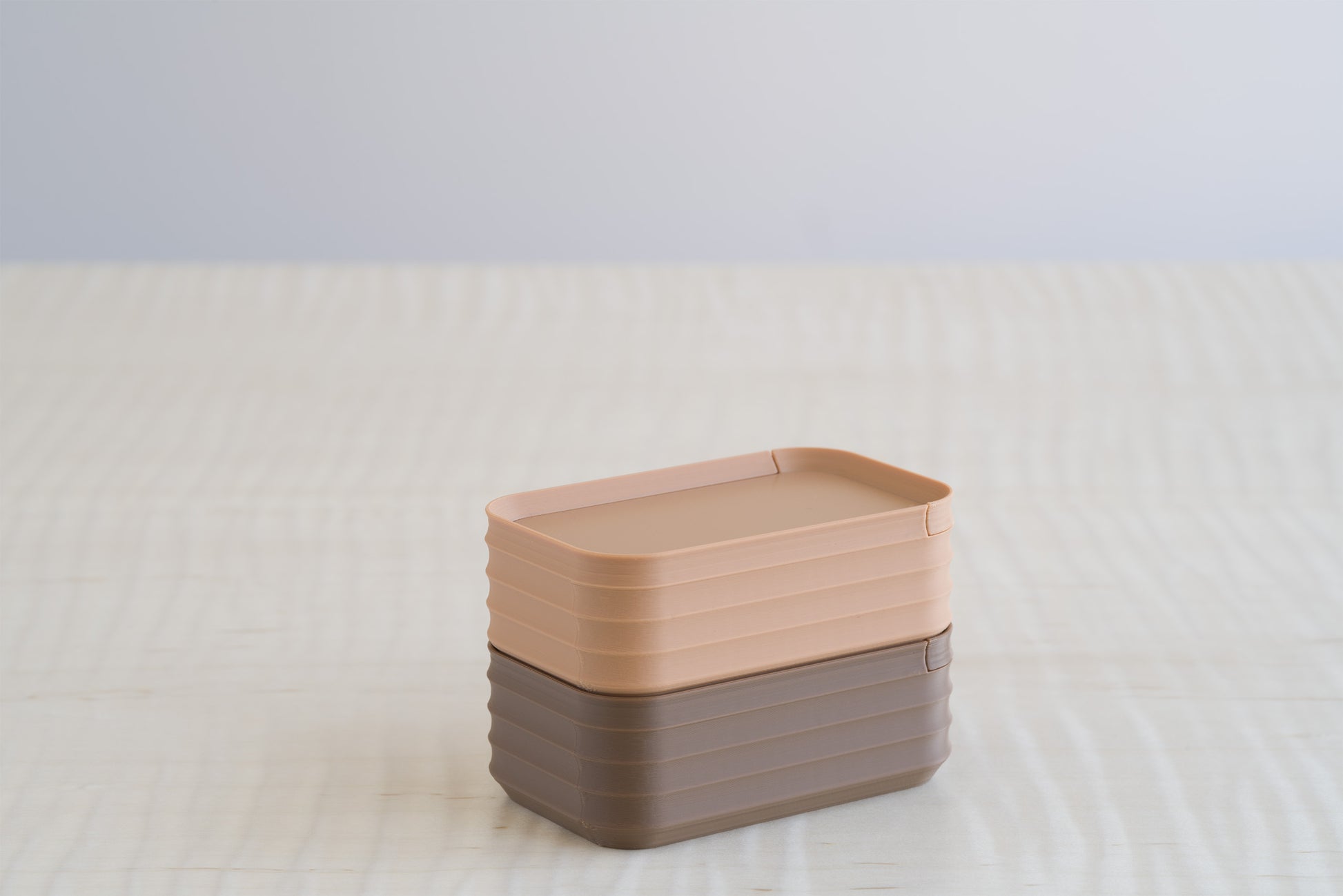 Rib Series Mini Boxes in matte caramel tan and cocoa brown, stacked together on a light wood surface for color comparison.