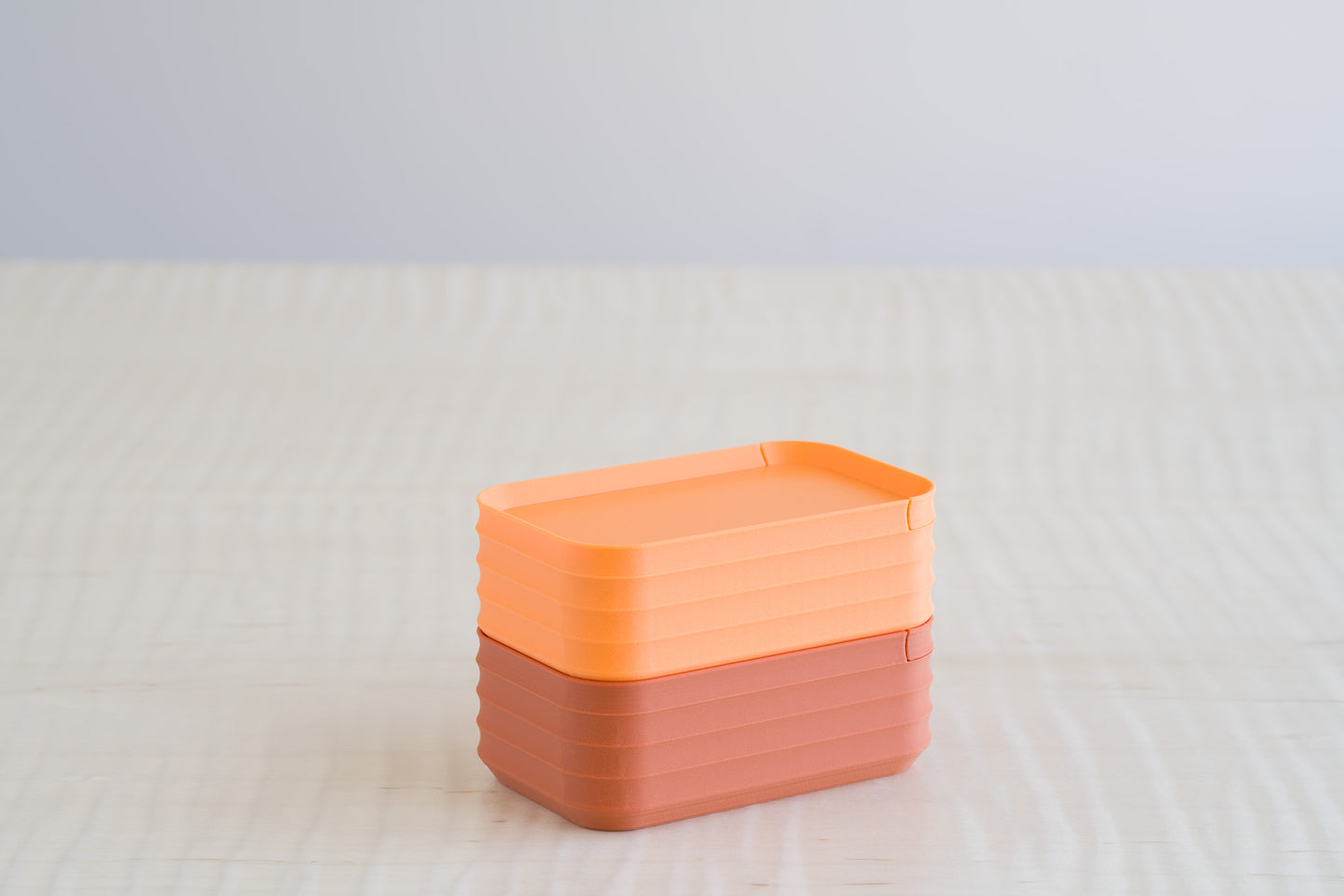 Two stacked Z Co Rib Series mini boxes in matte orange and terracotta finishes, paired side by side for a warm-toned color comparison.