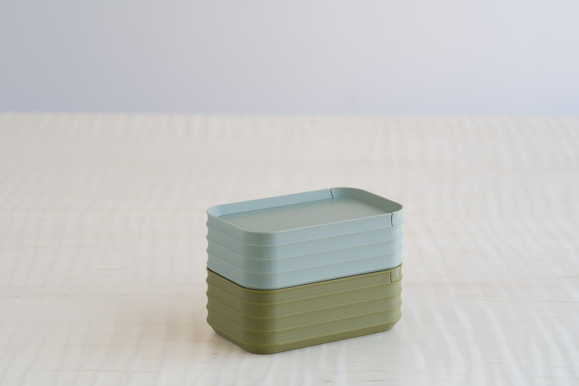 Two stacked Z Co Rib Series mini boxes in muted green and matte army green, photographed together for color comparison on a neutral background.