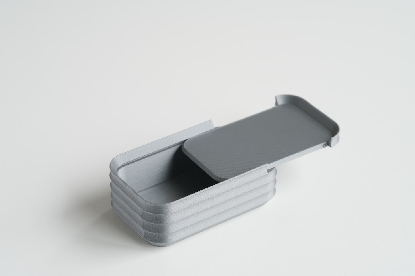 Silver mini box by Z Co with sliding lid halfway open on white background