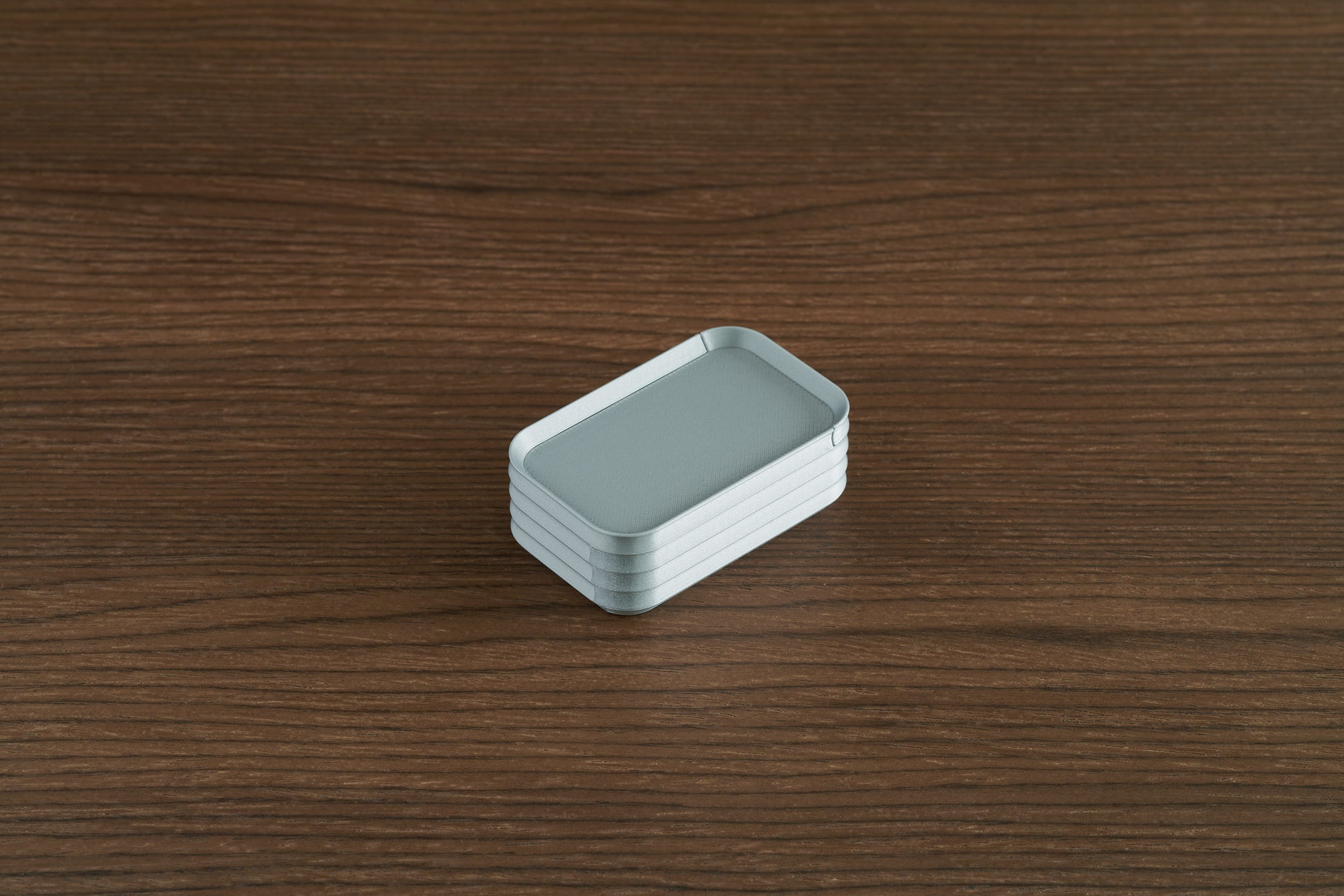 Silver Z Co mini box on walnut surface
